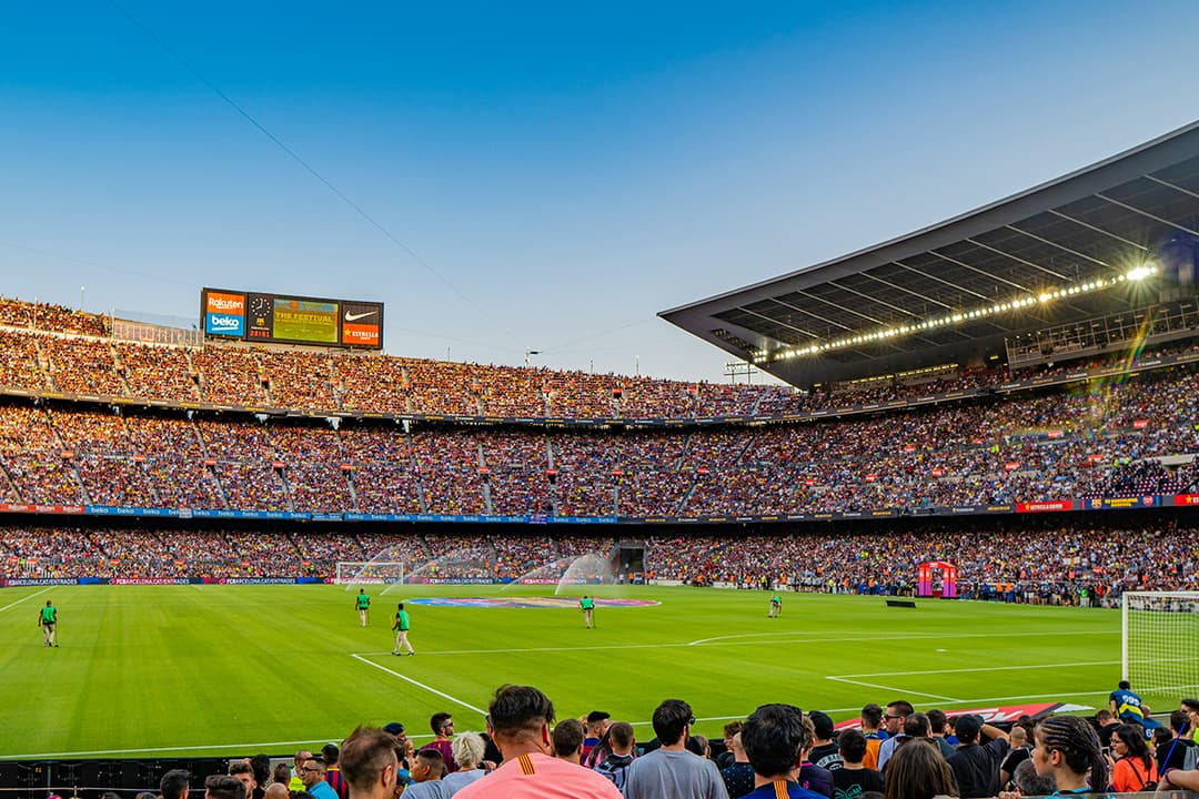 Crowded soccer stadium filled with fans during a match, representing a large-scale international football celebration.