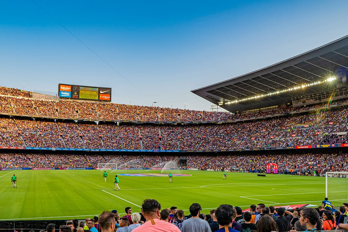 Crowded soccer stadium filled with fans during a match, representing a large-scale international football celebration.