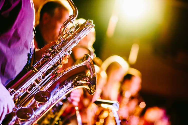 Saxophonist performing live under colorful stage lights at Jazz on the Bay.