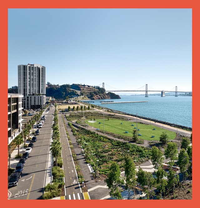 Aerial view of Cityside Park on Treasure Island with a waterfront lawn, walking paths, the Bay Bridge, and San Francisco Bay.